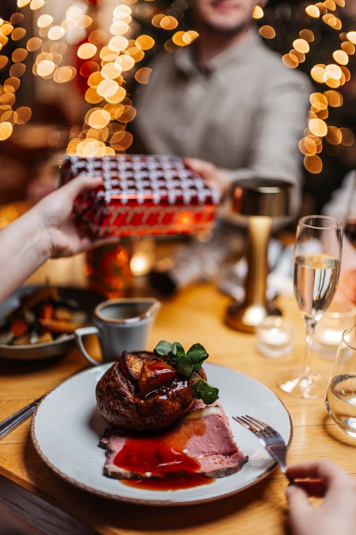 Christmas dinner while handing over a present
